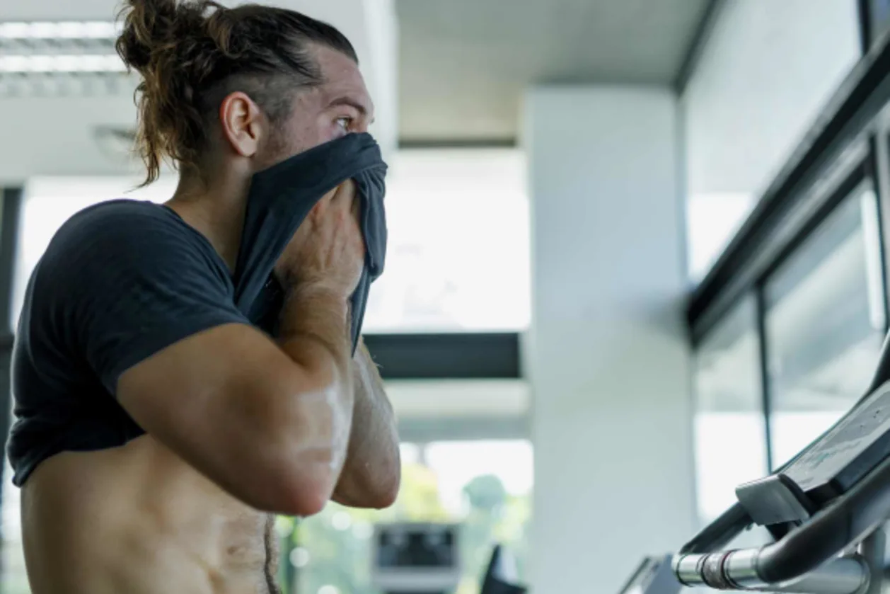 Close up of sweaty man on treadmill at sports performance retreat